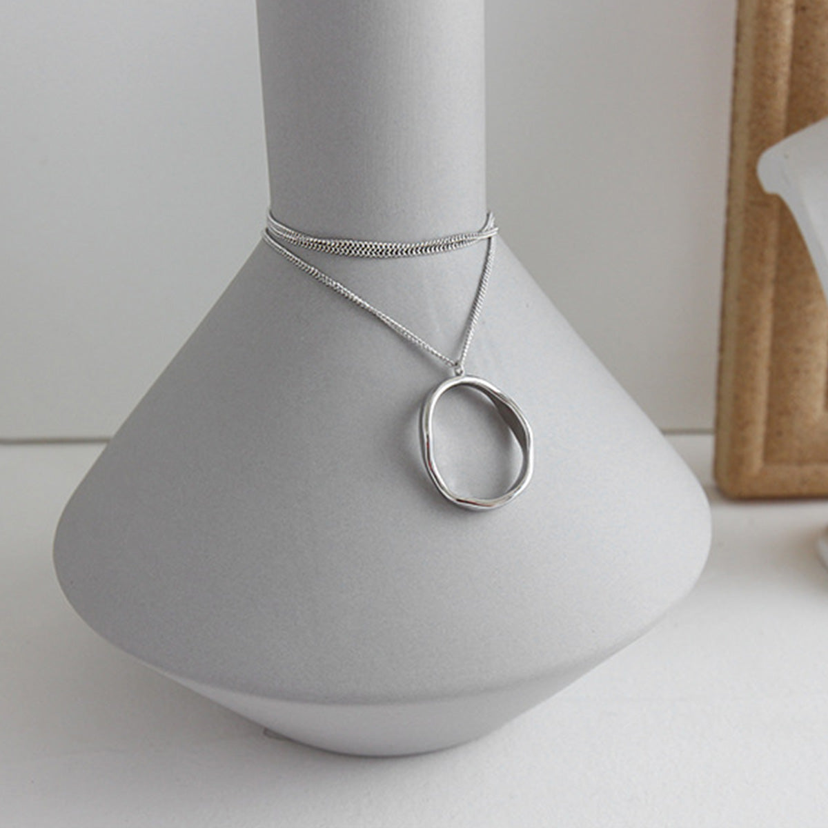 Close-up of gold irregular oval pendant necklace, minimalist jewelry wholesale piece ideal for bulk gift orders