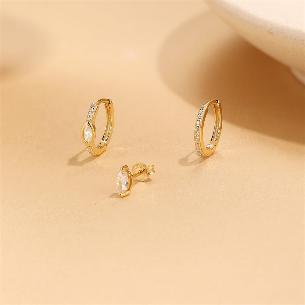 Product display of three gold S925 silver earrings including star engraved hoops and a sparkling flower stud.
