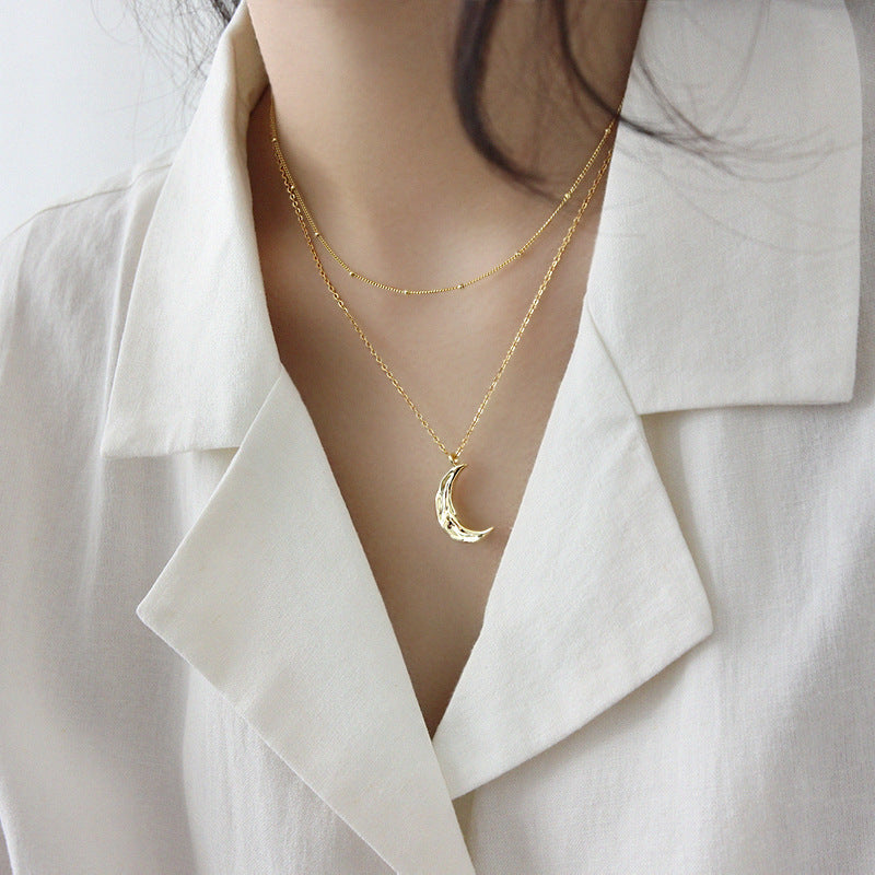 Model wearing silver crescent moon necklace on collarbone, perfect for wholesale minimalist jewelry and Korean pop style lovers.