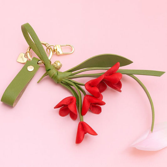 Red PU leather orchid keychain wholesale flower bag charm photographed on pink background