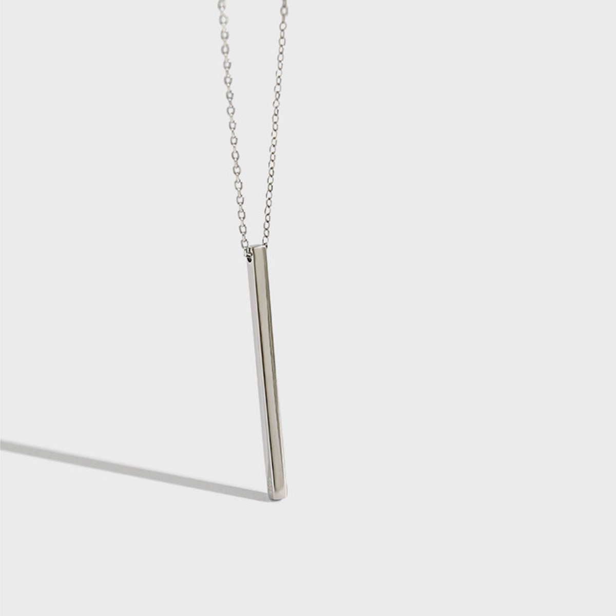 Close-up of 925 silver bar pendant necklace with clean shadow, perfect for wholesale silver minimalist jewelry for women