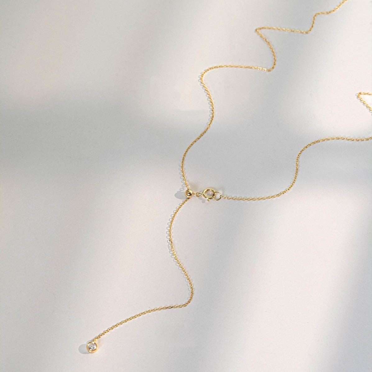 Wholesale S925 18K gold plated Y drop zircon necklace displayed flat with adjustable chain