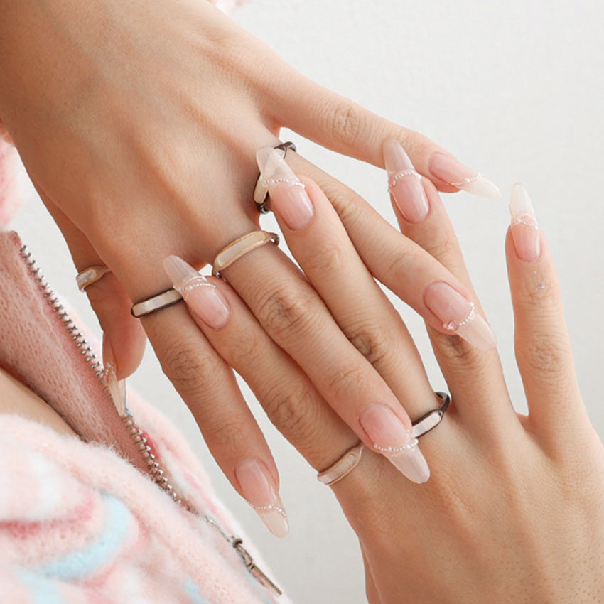 Neutral enamel shell inlay rings styled as a coordinated stack