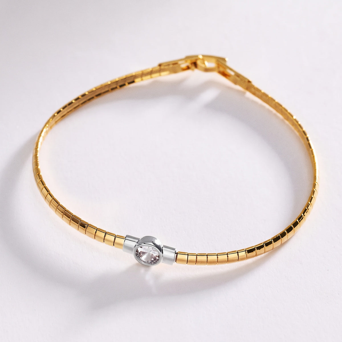 Stainless steel segmented bangle with round cubic zirconia
