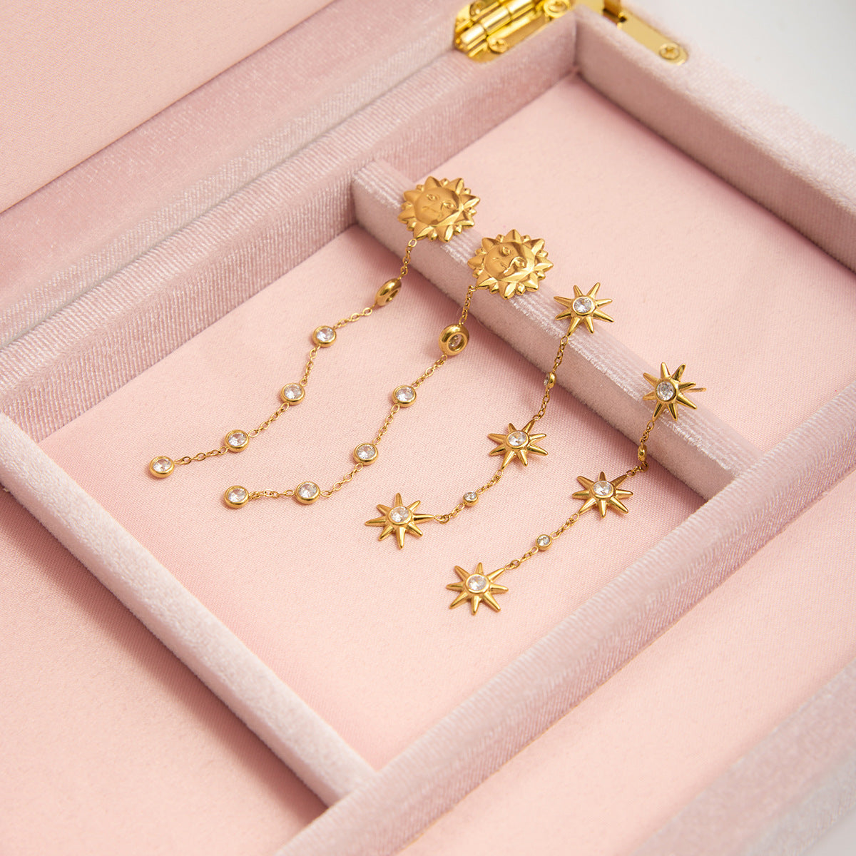 Gold stainless steel smiling sun zircon tassel earrings displayed in gift box