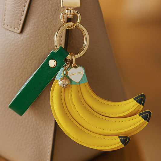 Banana fruit keychain yellow leather bag charm with green strap and gold hardware – trendy banana keyring accessory for handbags