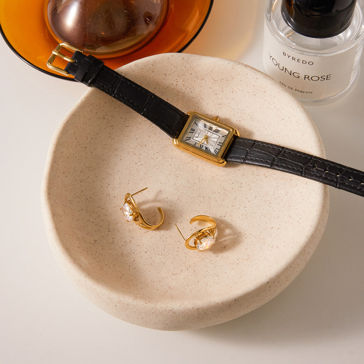 Gold stainless steel zircon C hoop earrings styled on tray