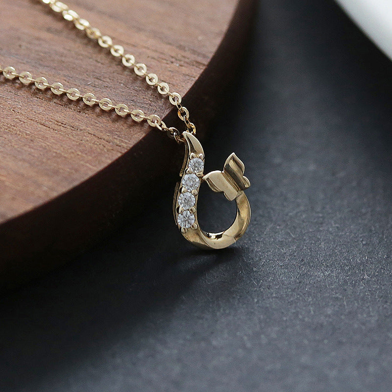 14K gold plated butterfly zircon pendant necklace displayed with gold chain on wood
