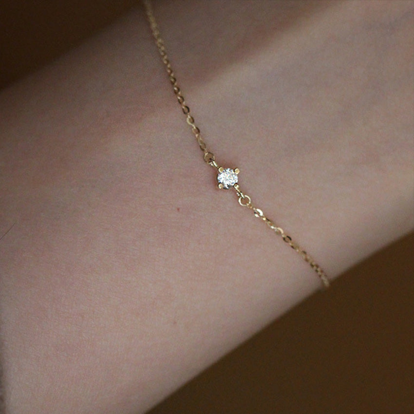 Solitaire cz gold plated sterling silver chain bracelet on wrist showcasing dainty wholesale jewelry style