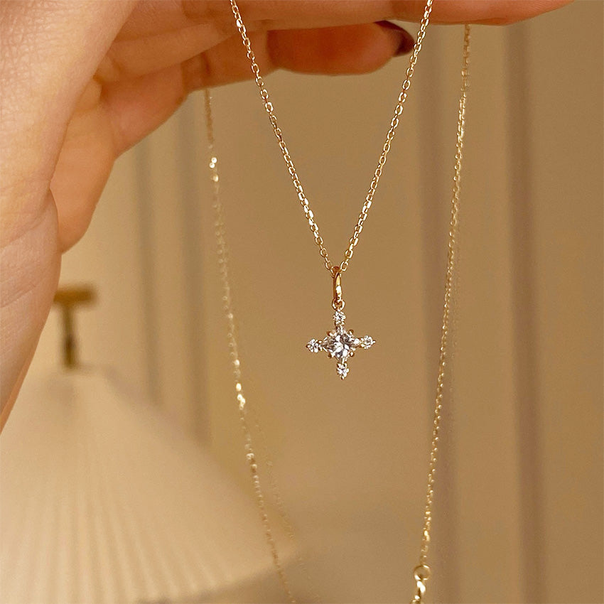 18K gold plated 925 silver zircon cross necklace held by hand
