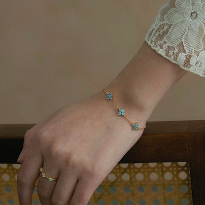 Delicate blue cz flower sterling silver gold bracelet styled with lace sleeve
