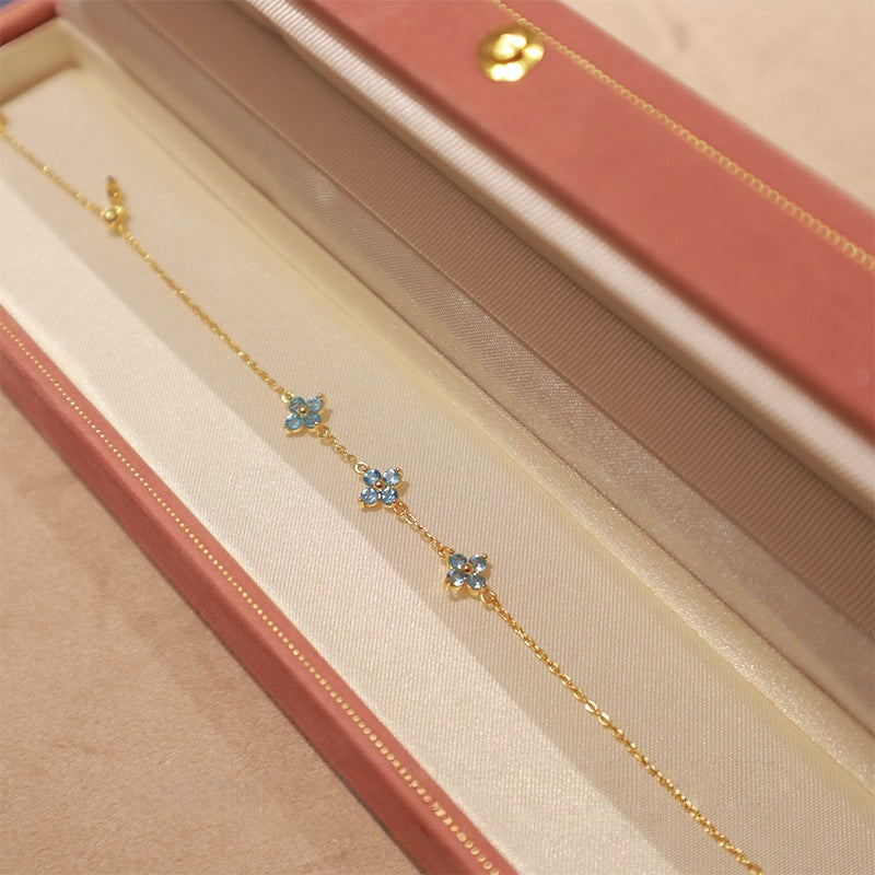 S925 gold plated blue clover chain bracelet displayed inside a pink gift box
