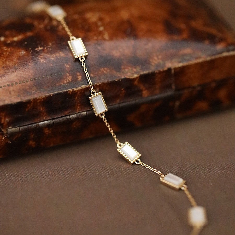 Minimalist dainty gold sterling silver layering bracelet worn on model wrist showcasing delicate everyday fashion look