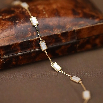 Minimalist dainty gold sterling silver layering bracelet worn on model wrist showcasing delicate everyday fashion look