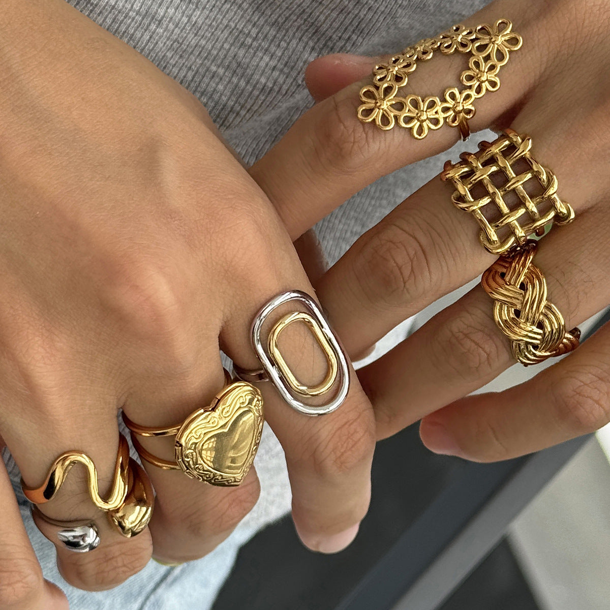 Openwork gold flower wreath ring worn as an elongated statement accessory