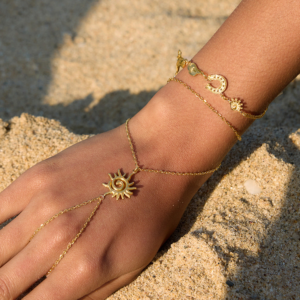 18K gold plated sun hand chain bracelet with finger loop worn on the hand