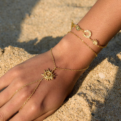 18K gold plated sun hand chain bracelet with finger loop worn on the hand