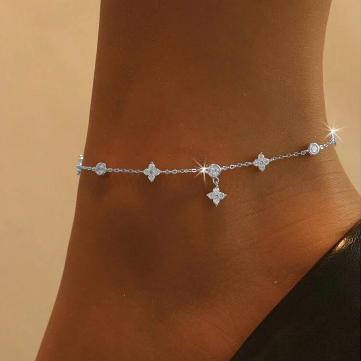 Solid 925 silver four leaf clover anklet displayed on a woman’s ankle

