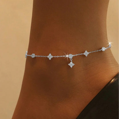 Solid 925 silver four leaf clover anklet displayed on a woman’s ankle

