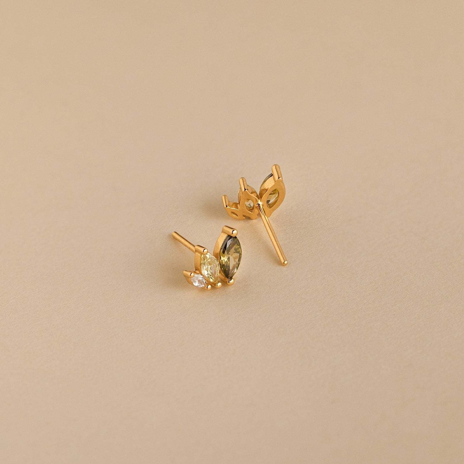 Close-up of gold marquise earrings with zircon sparkle, perfect for tropical outfits and summer beach jewelry collections