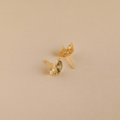 Close-up of gold marquise earrings with zircon sparkle, perfect for tropical outfits and summer beach jewelry collections