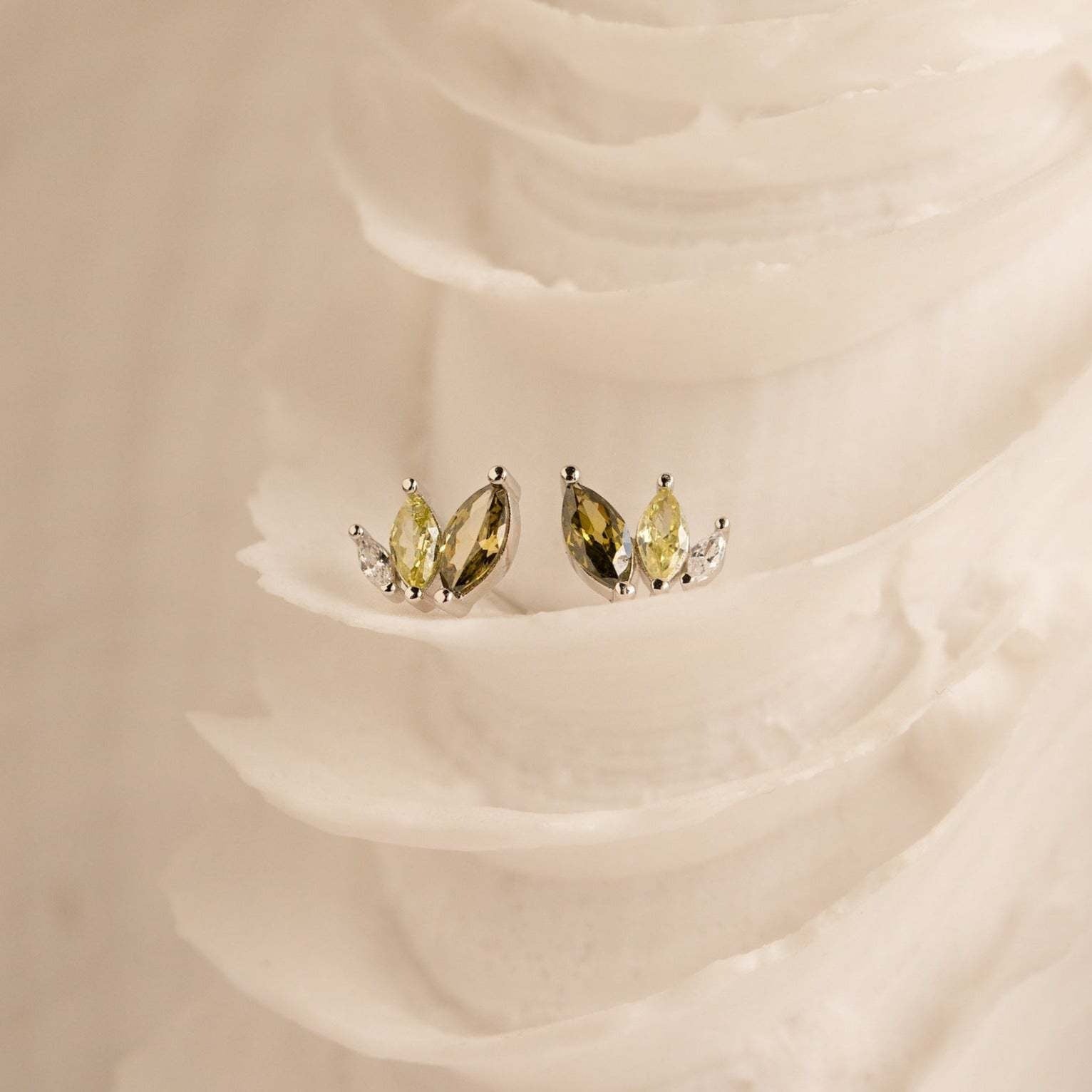 Dainty gold plated marquise CZ earrings on a natural fabric background, featured as lightweight summer beach jewelry