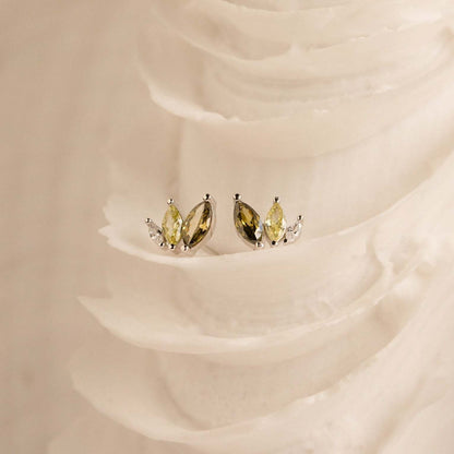 Dainty gold plated marquise CZ earrings on a natural fabric background, featured as lightweight summer beach jewelry
