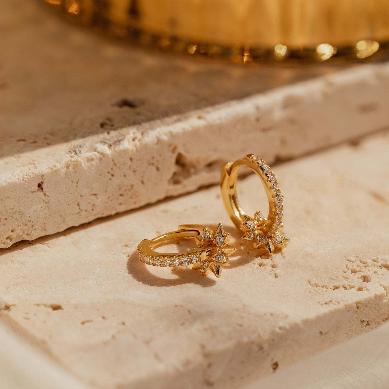 Removable star hoop earrings in gold-plated sterling silver with CZ details, styled as an elegant gift for Christmas or Valentine’s Day