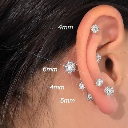 Elegant stud earrings set with faceted crystals, displayed on a neutral background for a clean jewelry presentation