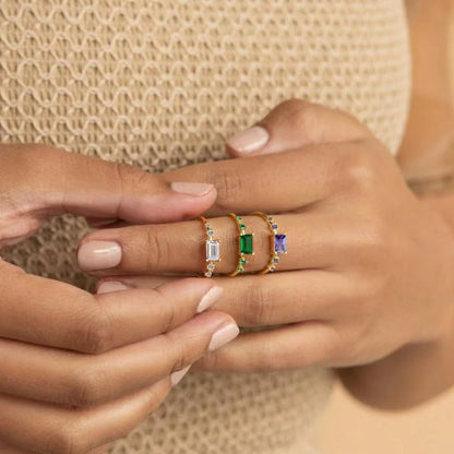 
colorful baguette cut cubic zirconia rings in white green and purple on gold band