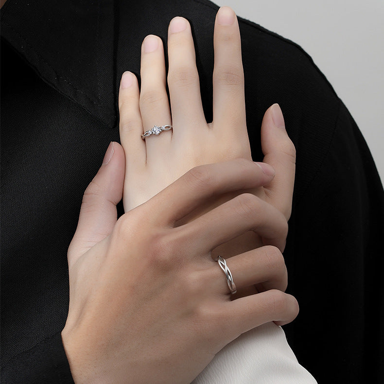 matching his and hers silver rings with interwoven twist bands and stone accents