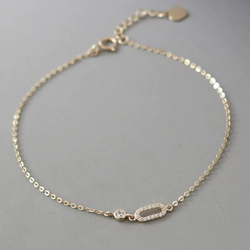 Close-up of 925 sterling silver 14K gold plated cubic zirconia baguette bracelet on wrist