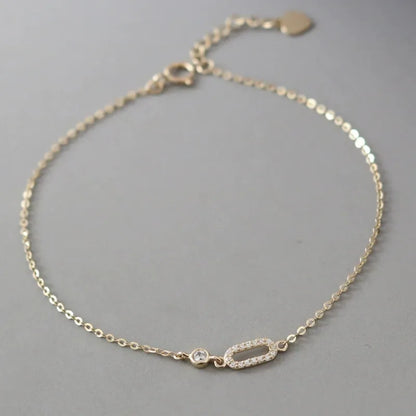 Close-up of 925 sterling silver 14K gold plated cubic zirconia baguette bracelet on wrist