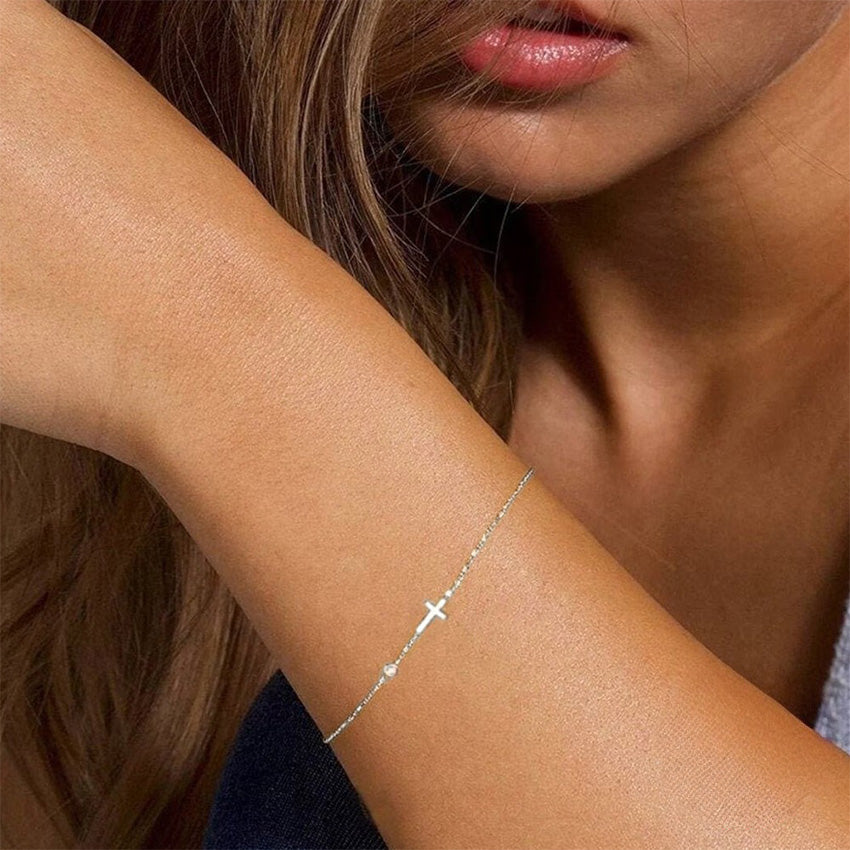 925 sterling silver bracelet with side cross and separated cubic zirconia charm in gold tone