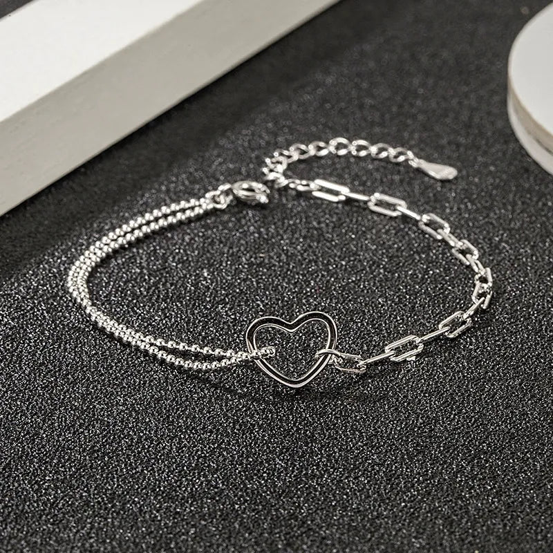 Delicate sterling silver double chain bracelet with open heart charm 
ideal for gifting