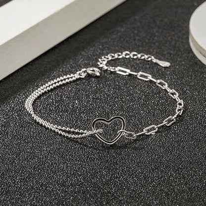 Delicate sterling silver double chain bracelet with open heart charm 
ideal for gifting