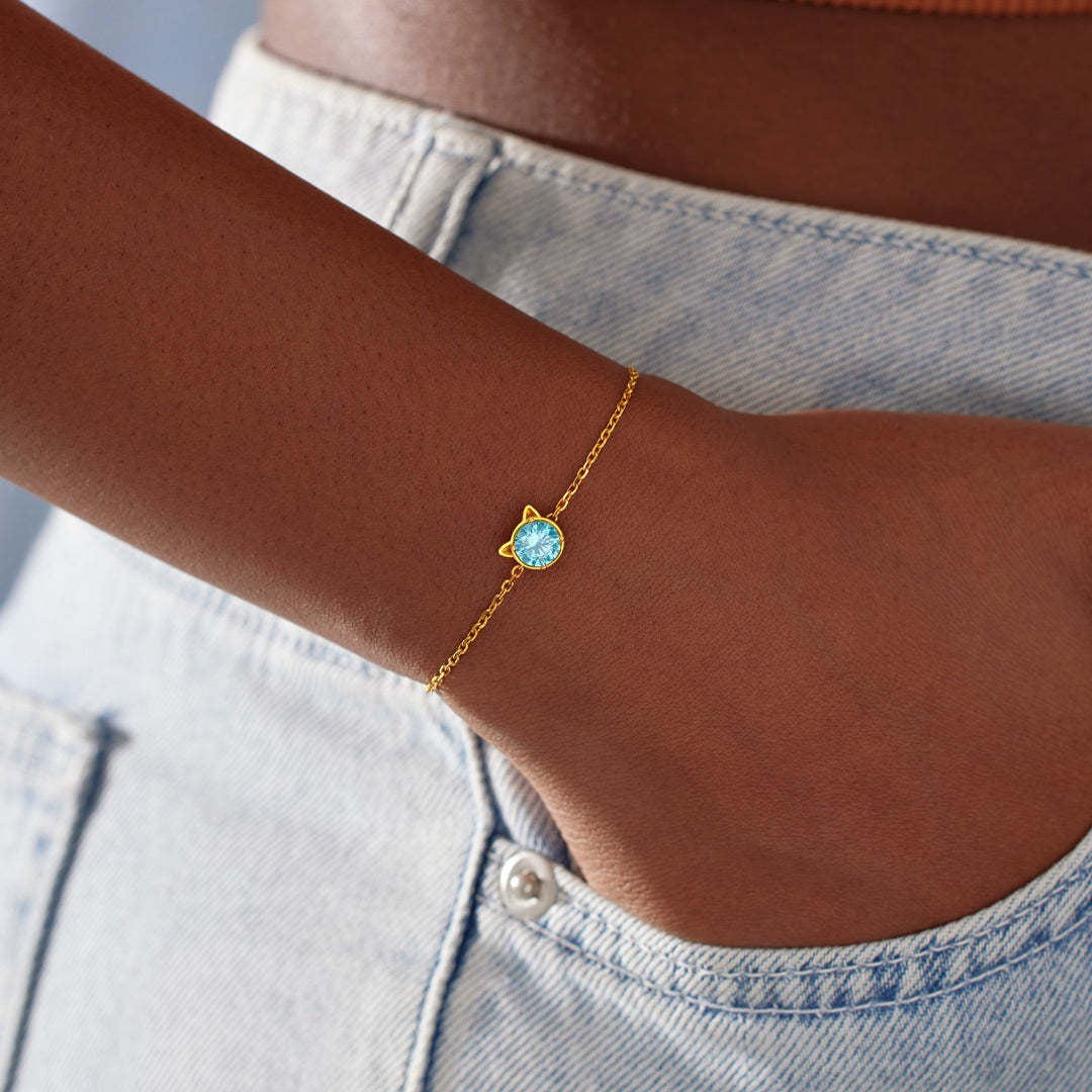 Minimalist gold cat bracelet with kitten ear design and blue cubic zirconia center