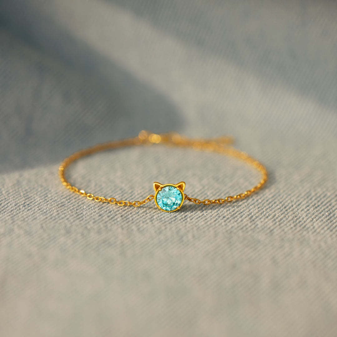 Dainty gold charm bracelet with cat ear motif and blue CZ, great birthday gift for her