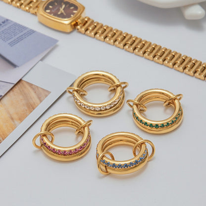 Set of four gold PVD plated stainless steel rings with cubic zirconia in white, green, pink, and blue, waterproof and hypoallergenic