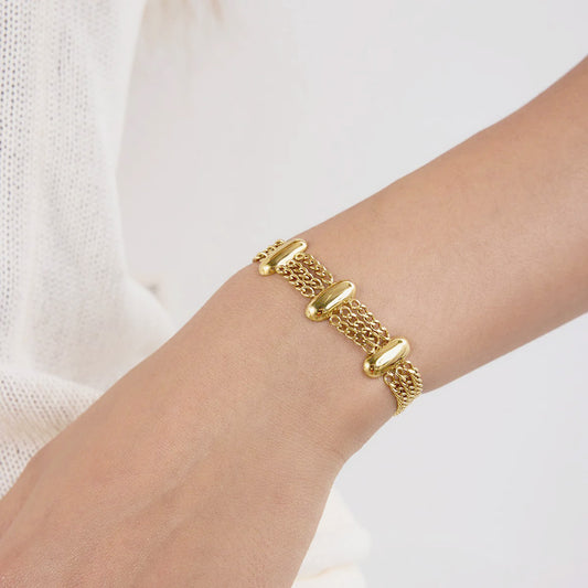 Close-up of a stainless steel Layered Chain Gold Bracelet worn by a woman, part of a fashion jewelry set with a sleek and modern style.
