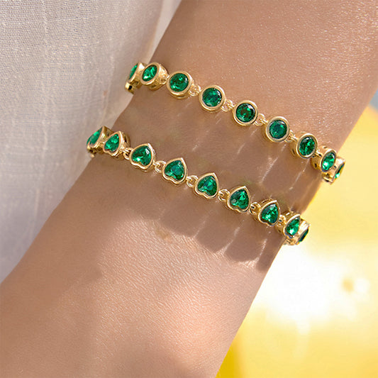 Close up of stainless steel green heart bracelet on wrist part of valentine jewelry collection and a trendy gift idea for women available for wholesale.