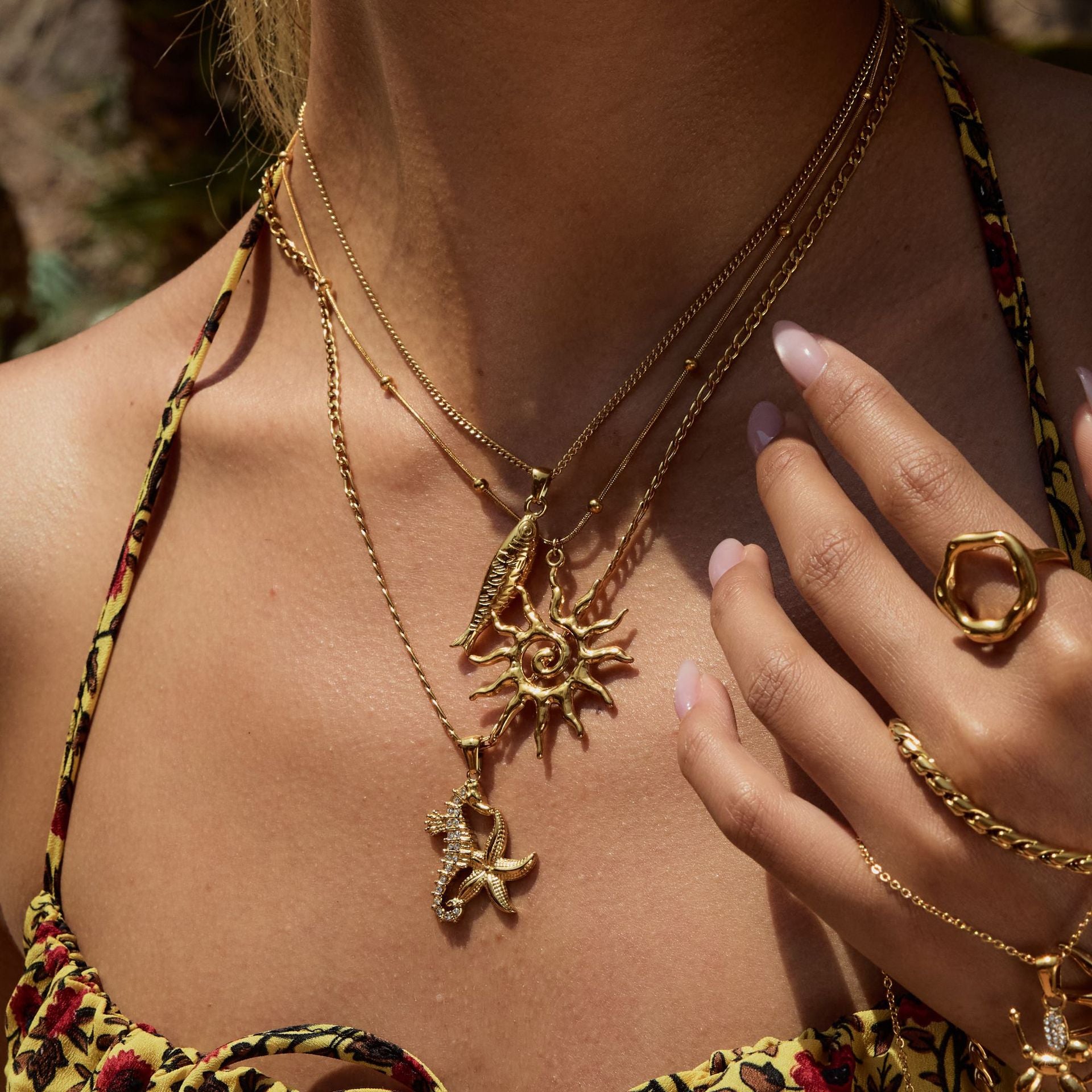 Minimalist 18k gold plated stainless steel necklace with hollow sun pendant, ideal as women’s summer jewelry and beachwear accessory.
