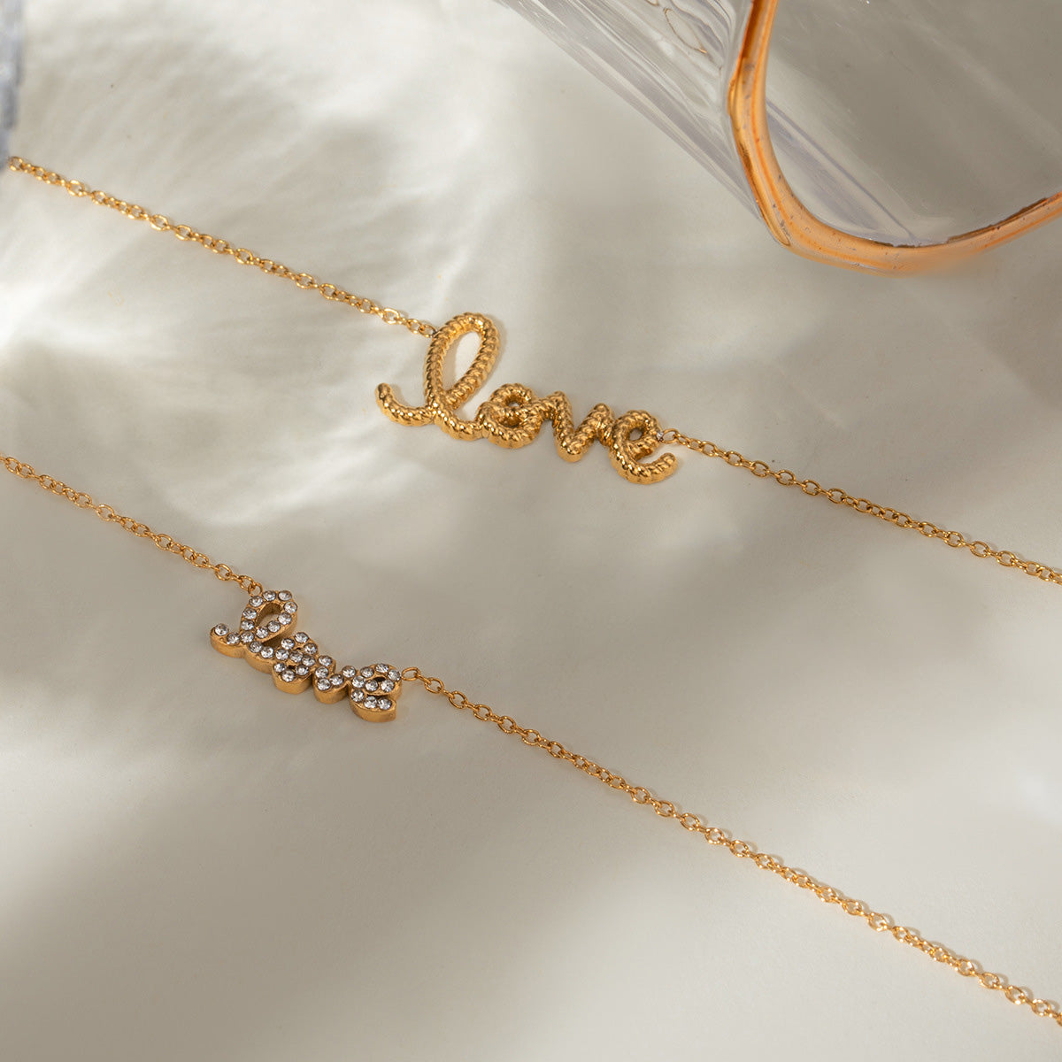 Close-up of the gold love letter necklace on model's neck, showcasing anti tarnish gold choker chain and delicate lettering pendant.