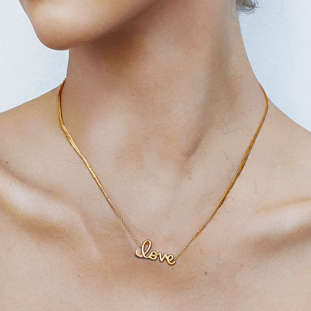 Elegant gold love letter necklace photographed with soft light, highlighting dainty chain style and i love you necklace for girlfriend vibe.
