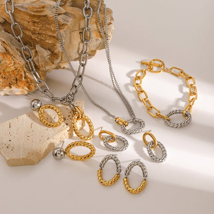 Complete jewelry set featuring two tone oval twist earrings, bracelet, and necklace. Ideal stainless steel jewelry set for women, showcasing chunky geometric pieces for wholesale or gifting.