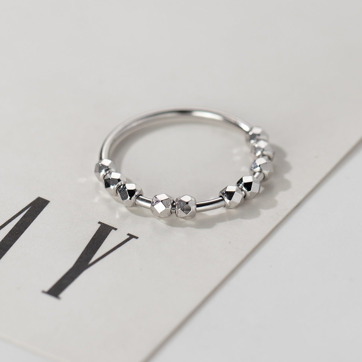 S925 sterling silver disco bead ring worn on finger with reflective faceted bead design