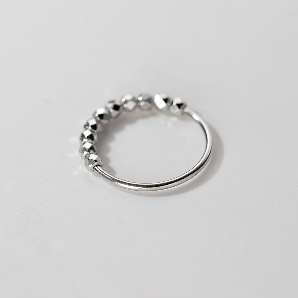 Adjustable sterling silver ring featuring diamond cut faceted beads