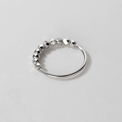 Adjustable sterling silver ring featuring diamond cut faceted beads