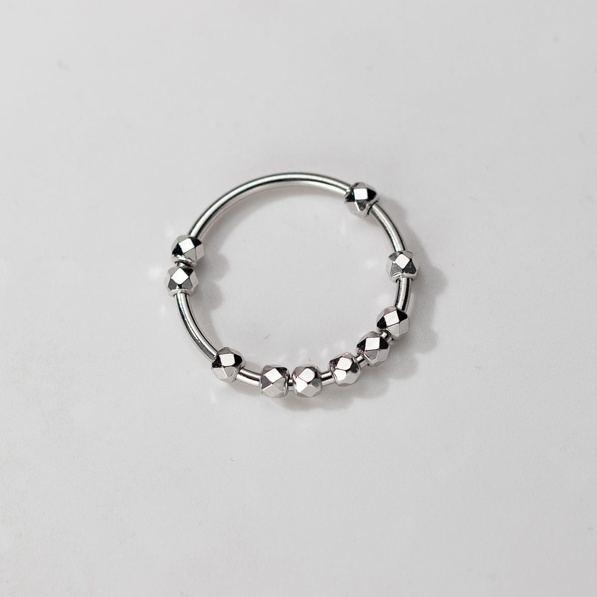 Open adjustable sterling silver bead ring with geometric faceted details