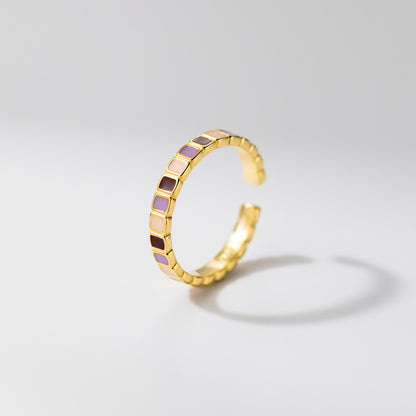 Side view of wholesale 925 sterling silver adjustable color block enamel geometric ring, gold band with purple, cream, and burgundy square patterns for fashion jewelry suppliers.